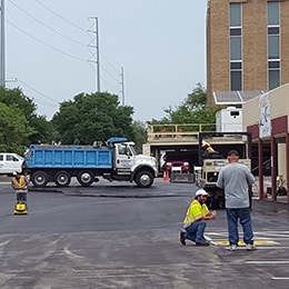 men working on parking lot striping